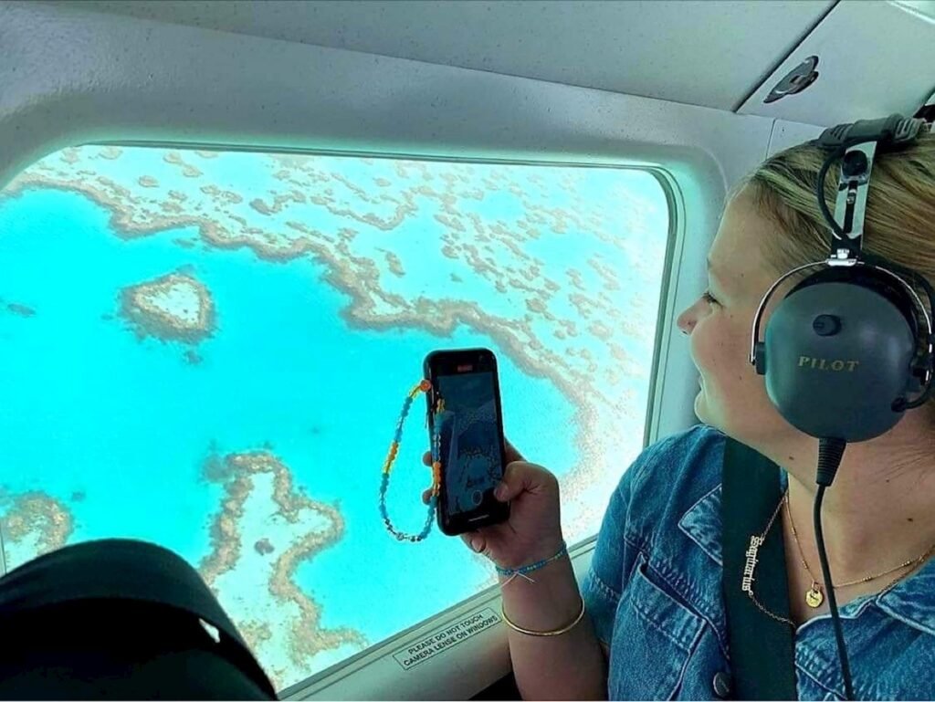 Side profile of someone taking a photo of the heart reef.