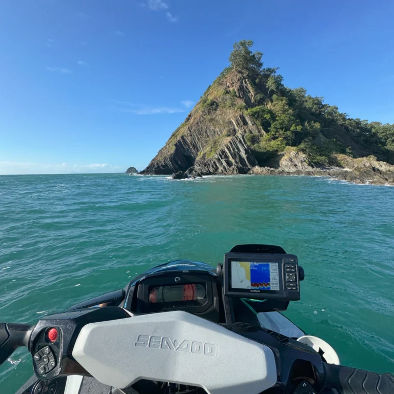 Photo taken from a person on a jet ski with views of an island in the distance.