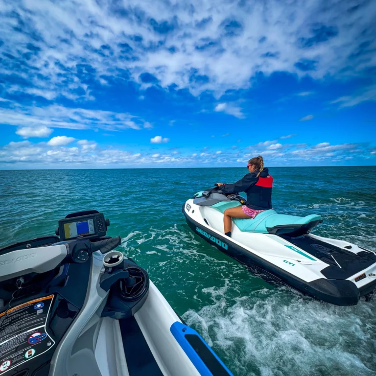 Two people riding a jet ski on the water on a jet ski tour.