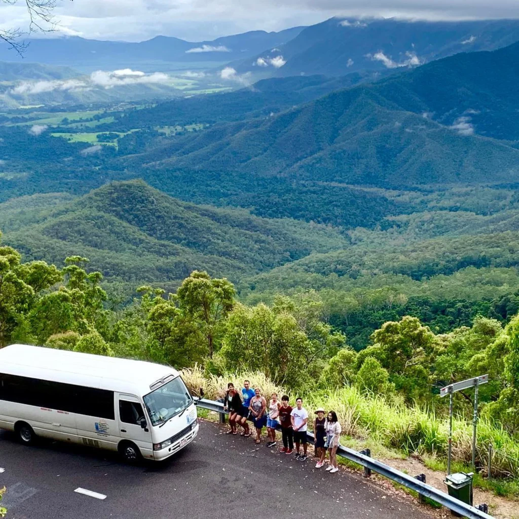 An aerial shot of a group getting out of a tour van to look at the scenic landscape of Atherton Tablelands.
