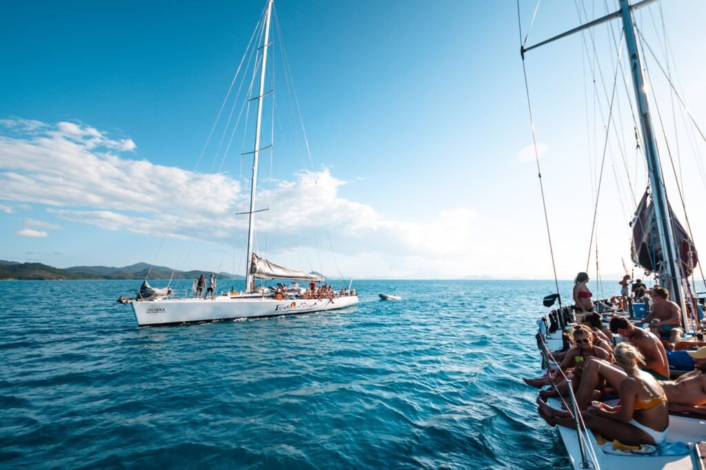 Wide shot of two sailing boats next to each other on the water.
