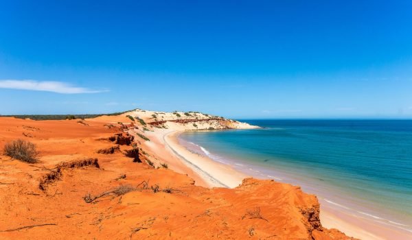 A wide shot of a red sandy beach in Western Australia.